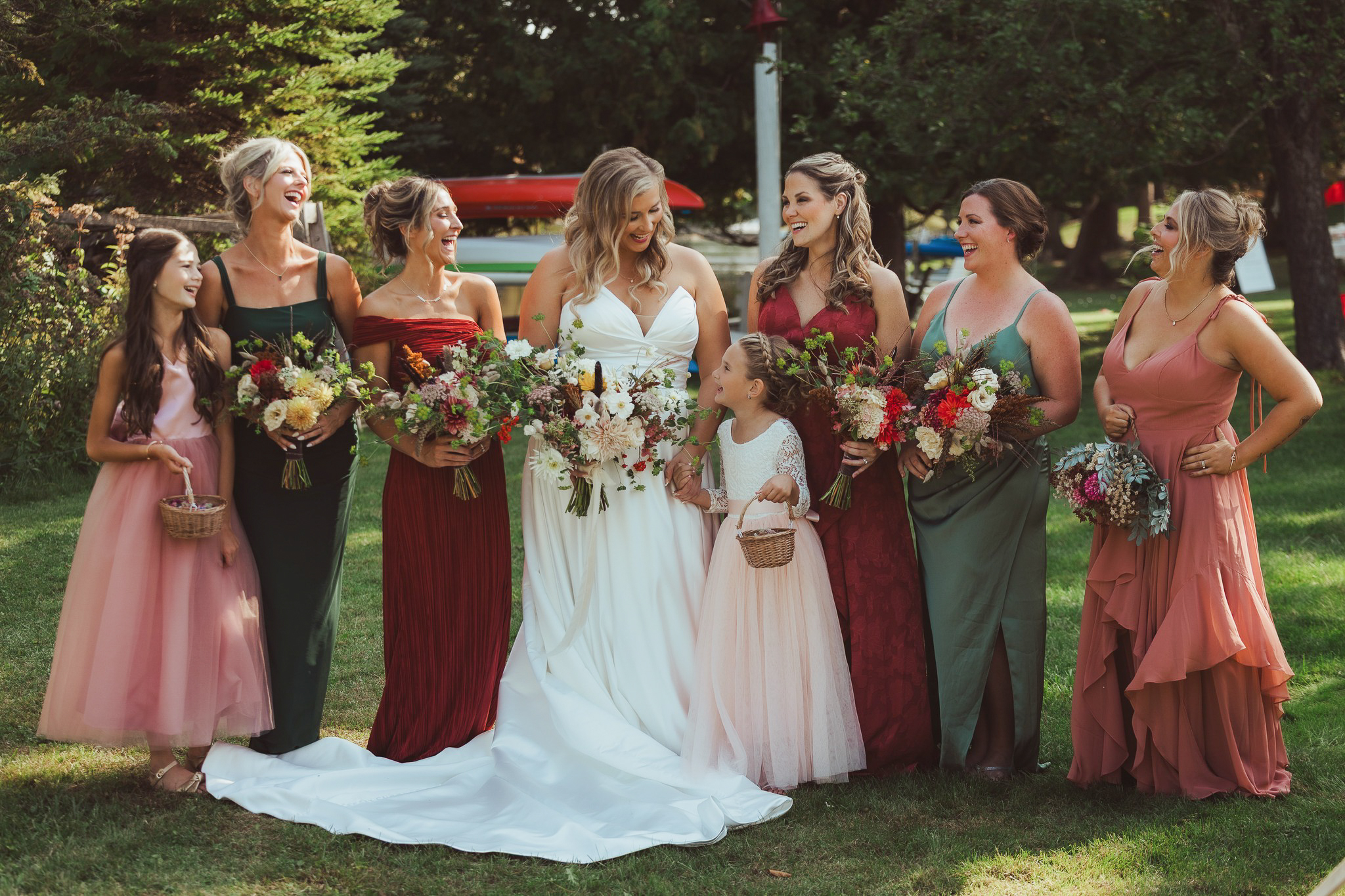 bride and bridesmaids laughing at wedding in glen arbor michigan traverse city photographer lina lavonne photograpy