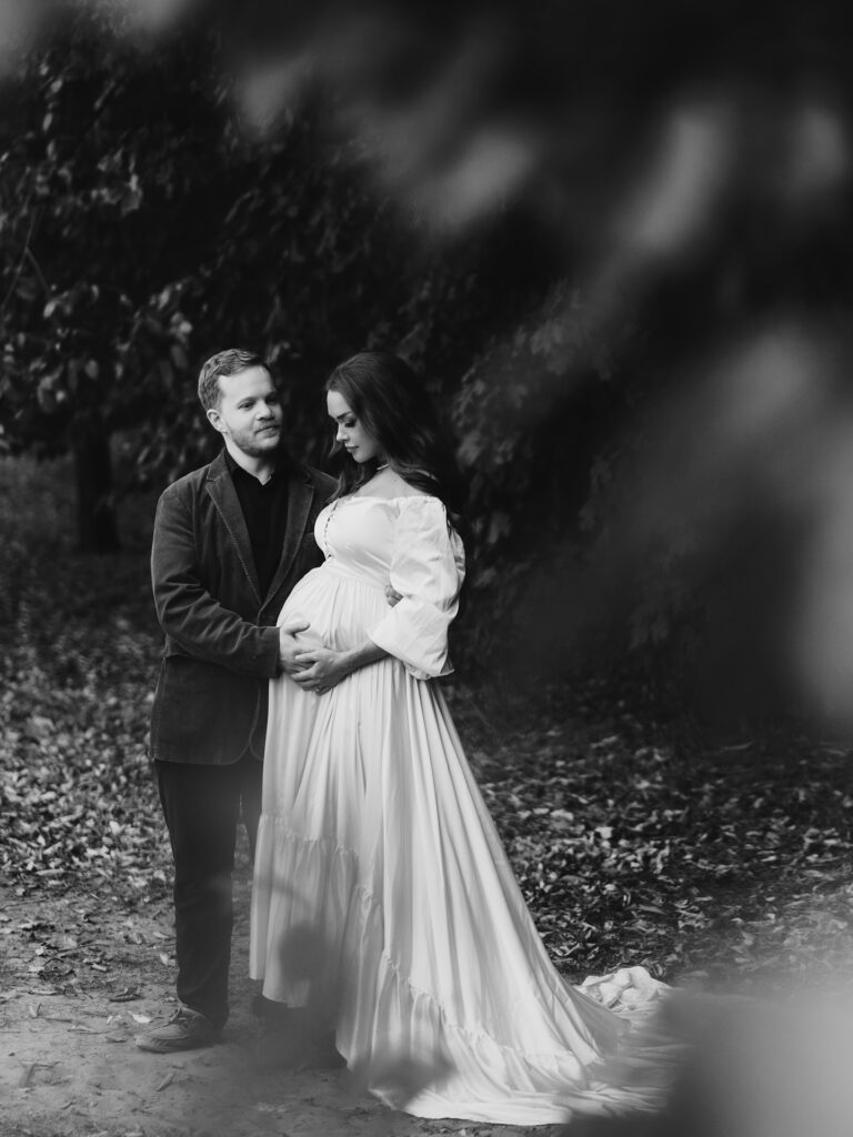 pregnant woman and man in family maternity pictures in traverse city photographer