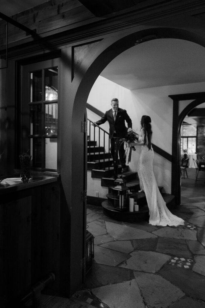 peninsula-room-traverse-city-photographer bride and groom walking up stairs at peninsula room traverse city wedding photography