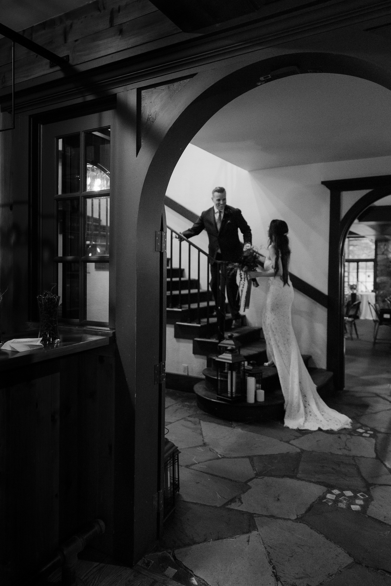 bride and groom walking up stairs at peninsula room traverse city wedding photography