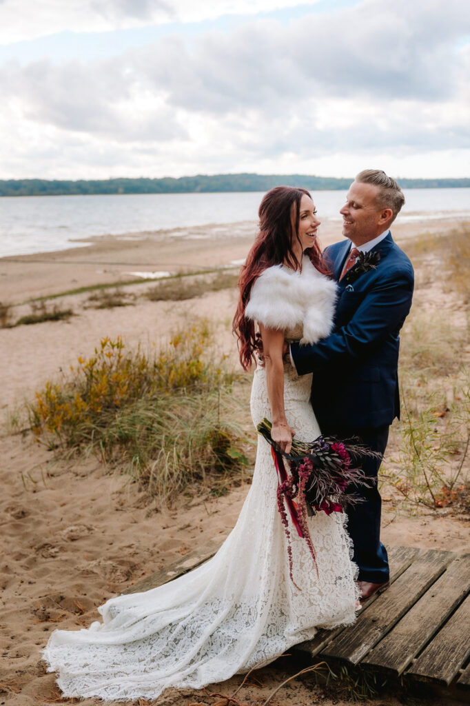 bride and groom on beach peninsula room traverse city wedding photography