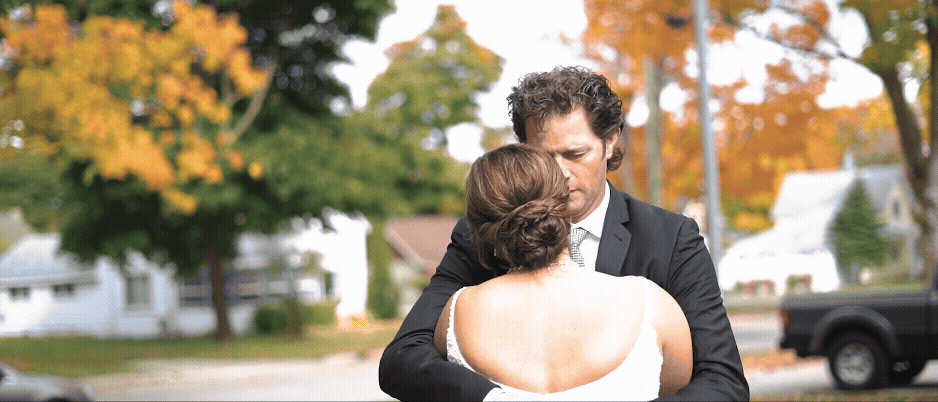 Bride being hugged by her father during first look at wedding at castle farms. wedding video by traverse city videographer lina lavonne