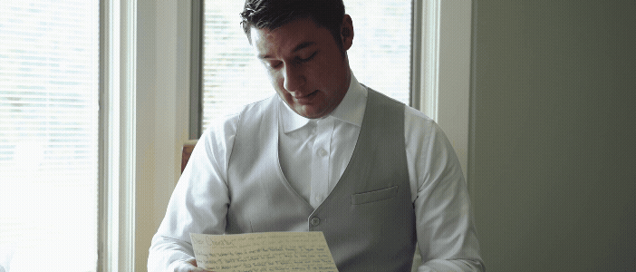 groom crying reading a letter from the bride before their castle farms wedding. video by traverse city wedding videographer