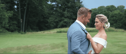 bride and groom dancing in field at grand traverse resort. video by traverse city wedding videographer