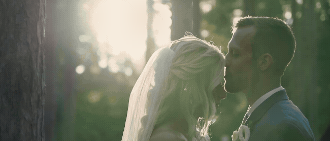 bride and groom kissing in woods at blue bridge event center grawn michigan