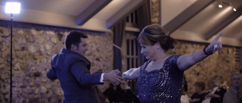 Groom and mother dancing at their Castle Farms wedding reception, captured by a Traverse City wedding videographer