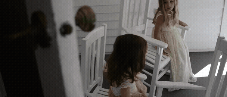 flowergirls sitting and rocking in chairs and spinning around at wedding. Aurora Cellars wedding