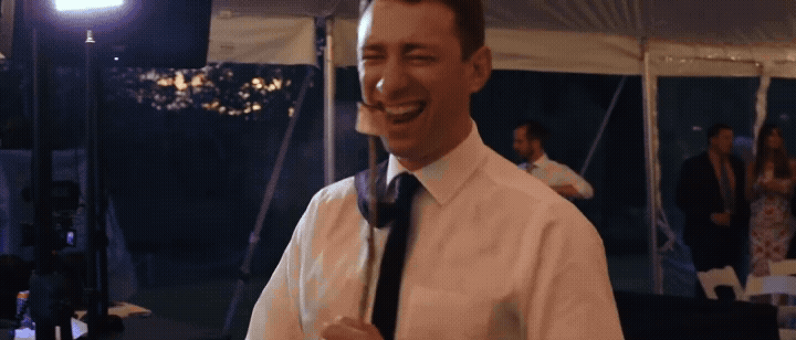 bride eating a marshmallow while dancing at wedding at aurora cellars. video by traverse city wedding videographer