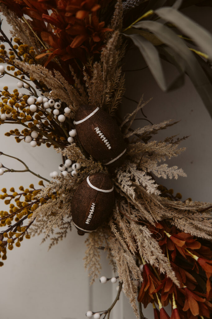close up of two decorative footballs on a door wreath in traverse city michigan