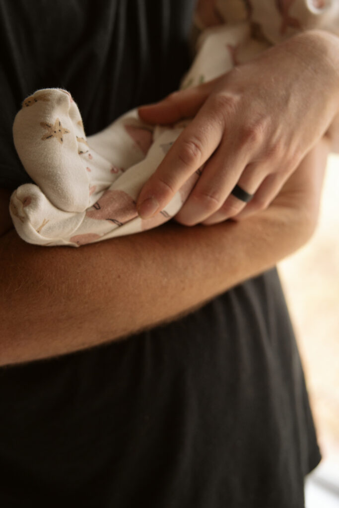 close up of babys feet during home newborn photos in traverse city michigan