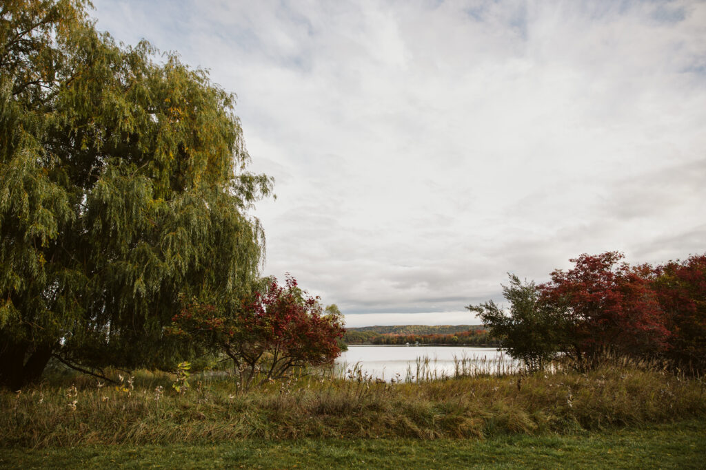 fall scenery of a lake on empire beach during family photo session in empire michigan. Photo by Lina Lavonne photography a traverse city photographer
