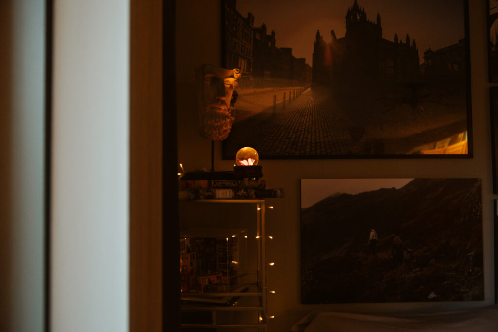 wall of pictures in a home during newborn photos in traverse city. Photo by Traverse City Photographer Lina Lavonne Photography