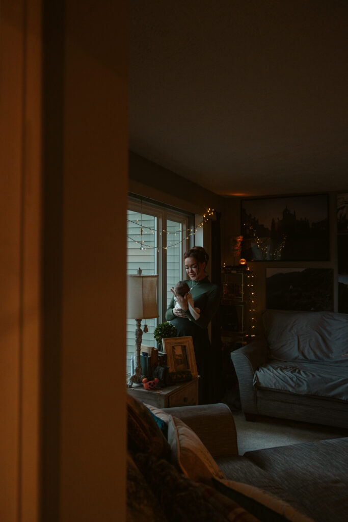 baby in the arms of his mother during newborn photos in traverse city. Photo by Traverse City Photographer Lina Lavonne Photography