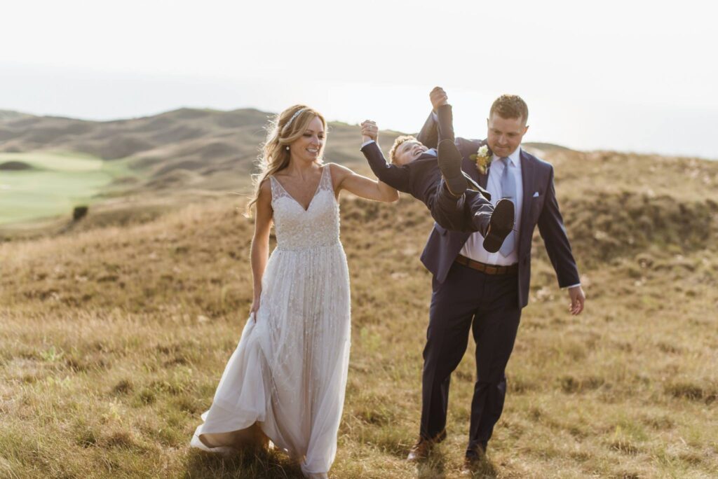 bride and groom swinging son at wedding in arcadia michigan