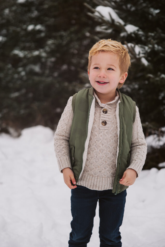 little boy smiling during family portraits in Traverse City Michigan