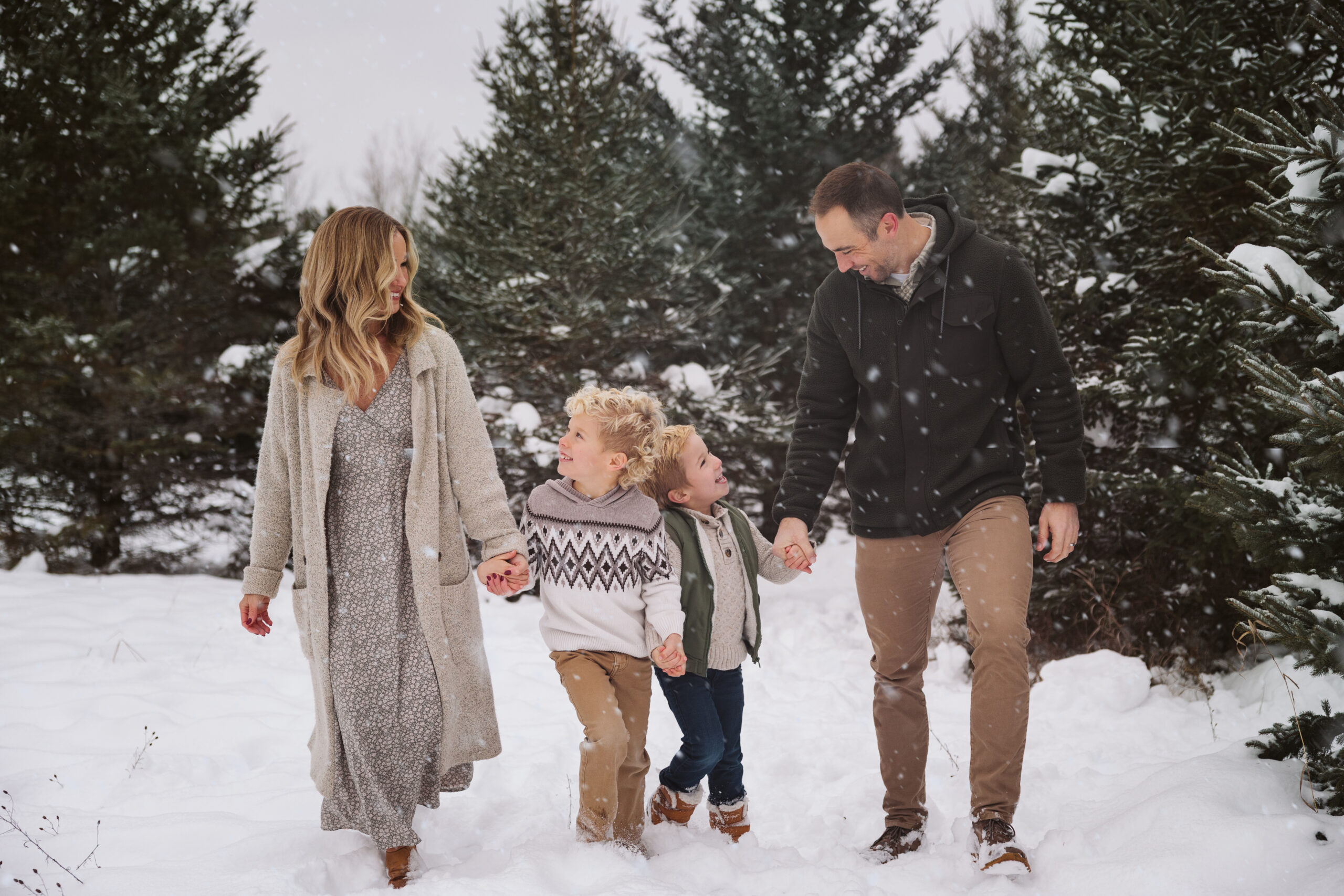 family huddled together with little boys laughing during family photos in traverse city