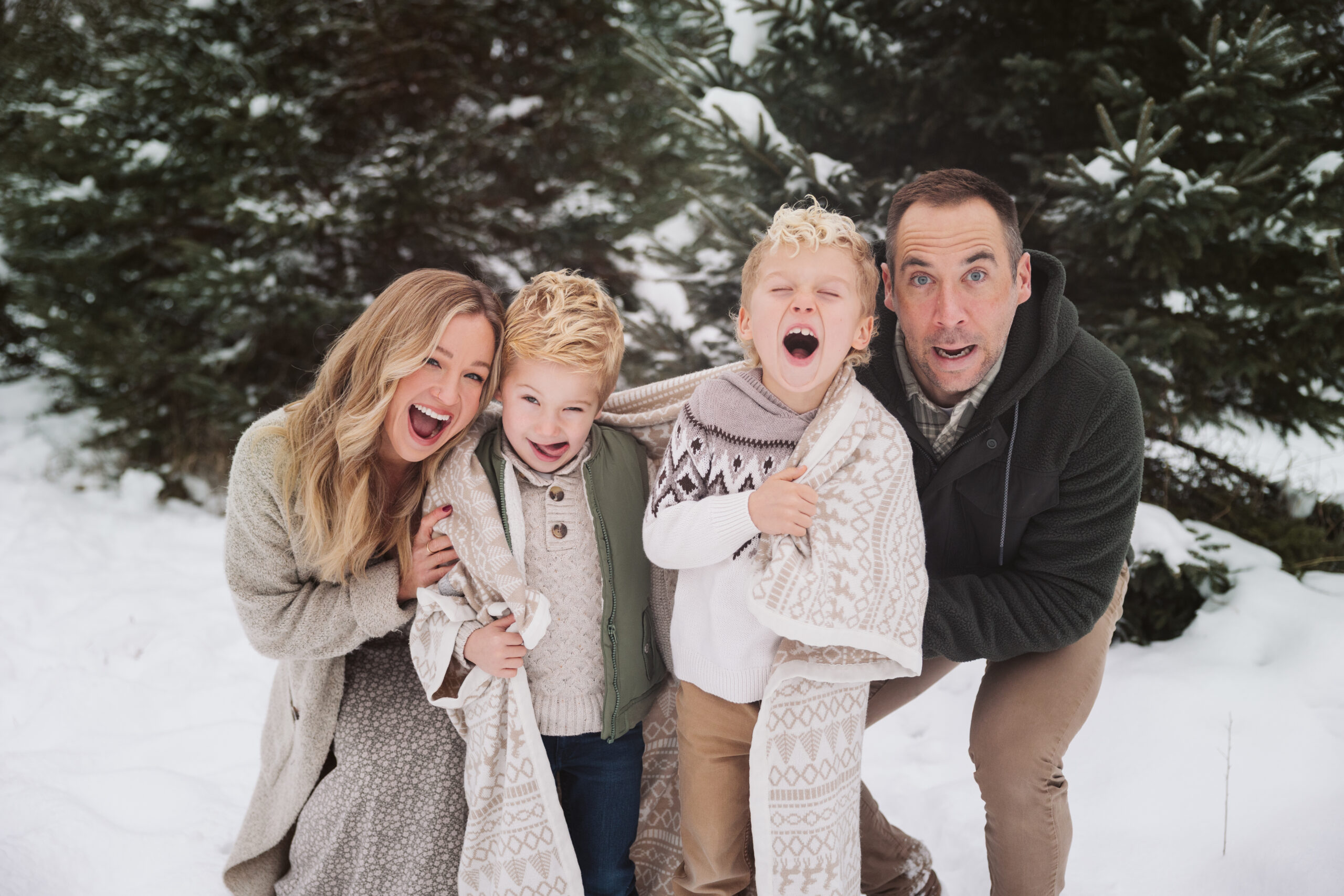 family of four making faces during christmas photos in traverse city