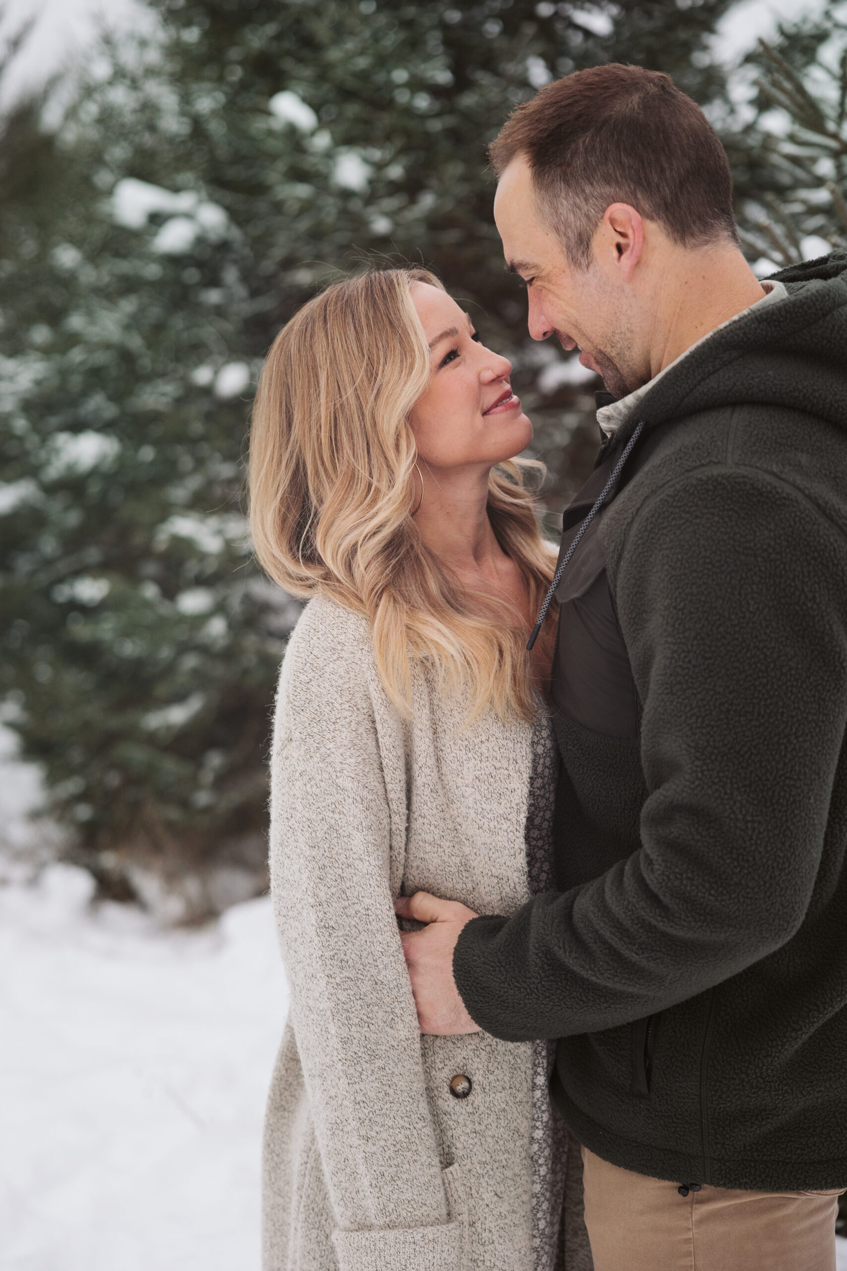 husband and wife looking at each other during christmas photos in traverse city