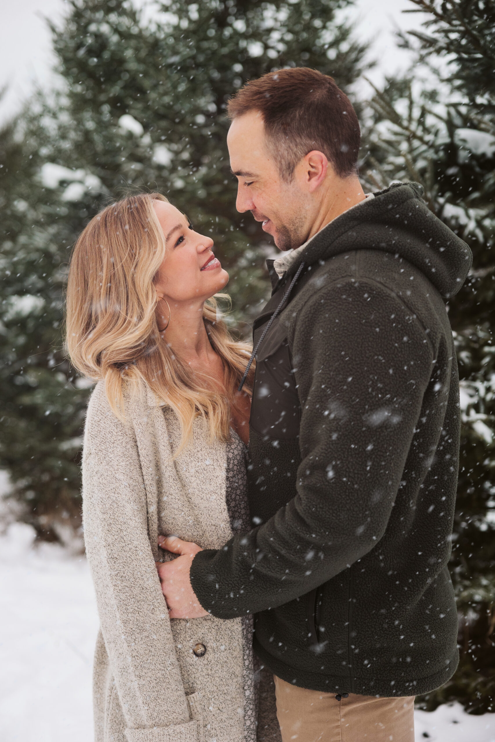 husband and wife cuddling during family portraits in traverse city