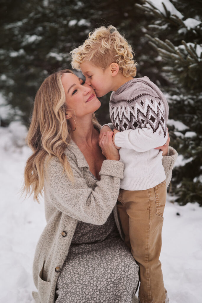 boy kissing his mom during family portraits in traverse city