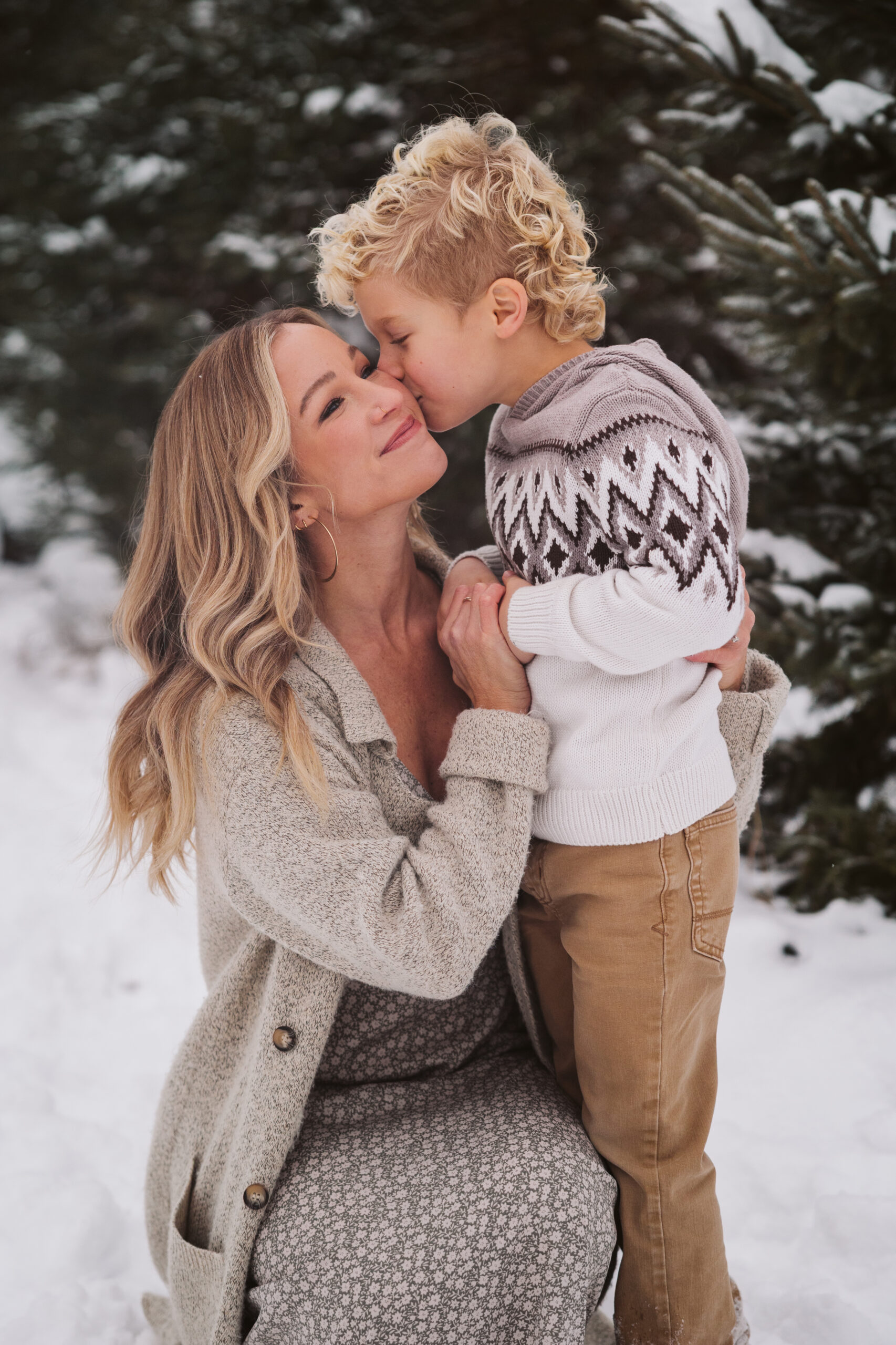 boy kissing his mom during family portraits in traverse city