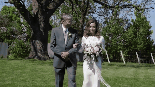 bride walking down the aisle at aurora cellars 
