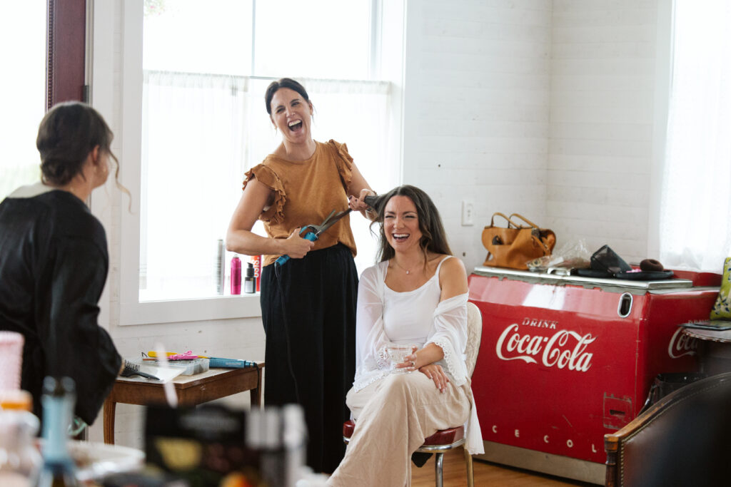 bride getting her hair and makeup done at general store airbnb at a general store at wedding in east jordan boathouse on lake charlevoix