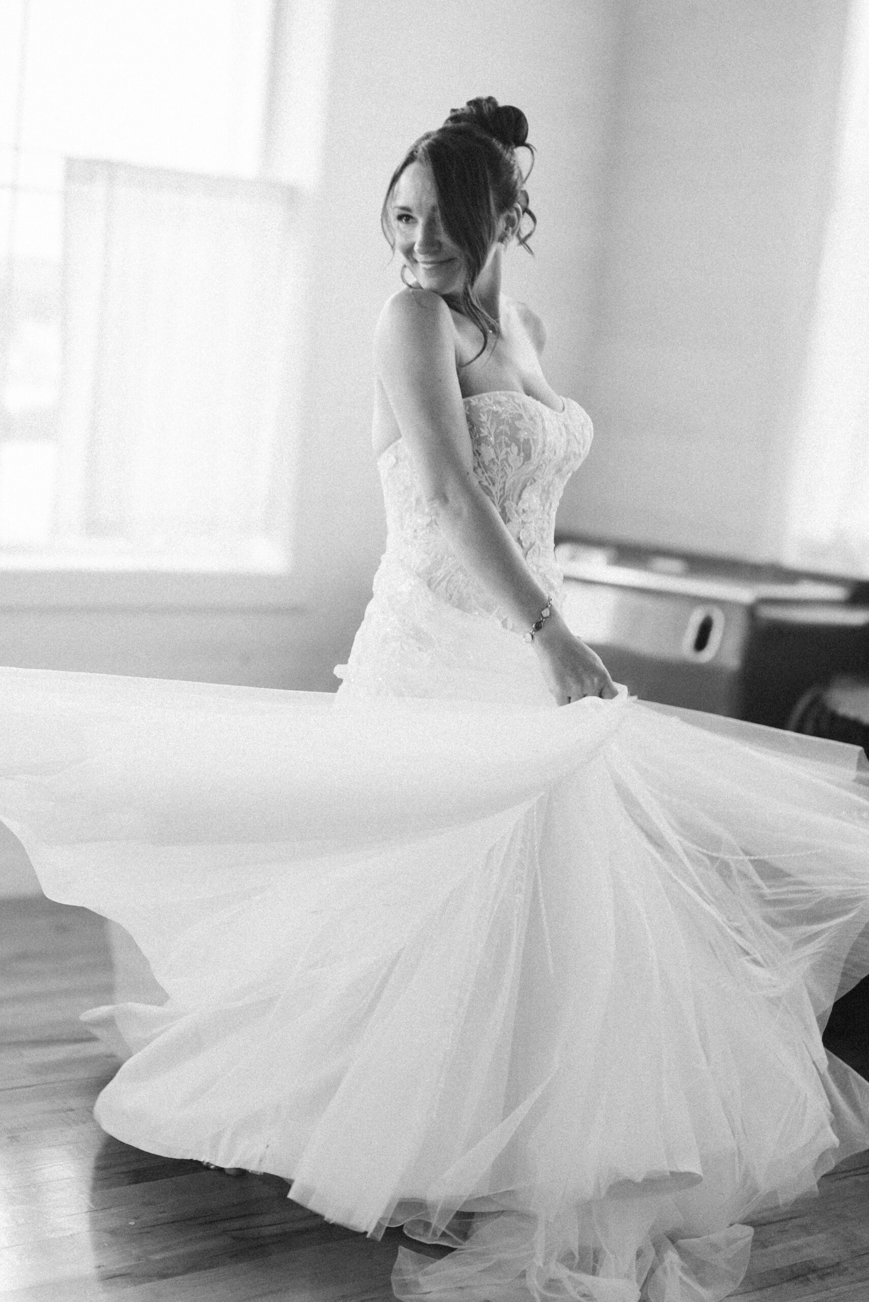 bride spinning around in general store at a general store at wedding in east jordan boathouse on lake charlevoix