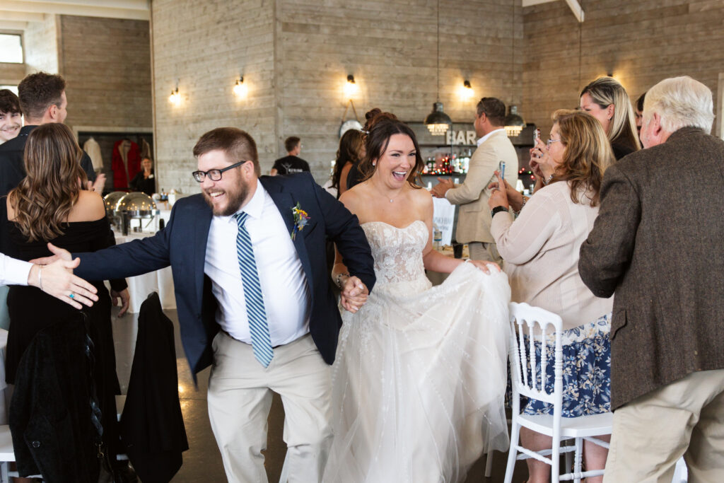 bride and groom walking into reception enterance at wedding in east jordan boathouse on lake charlevoix