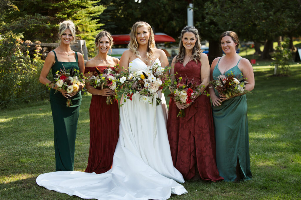 bride and bridesmaids at wedding in glen arbor michigan photo by traverse city wedding photographer and videographer