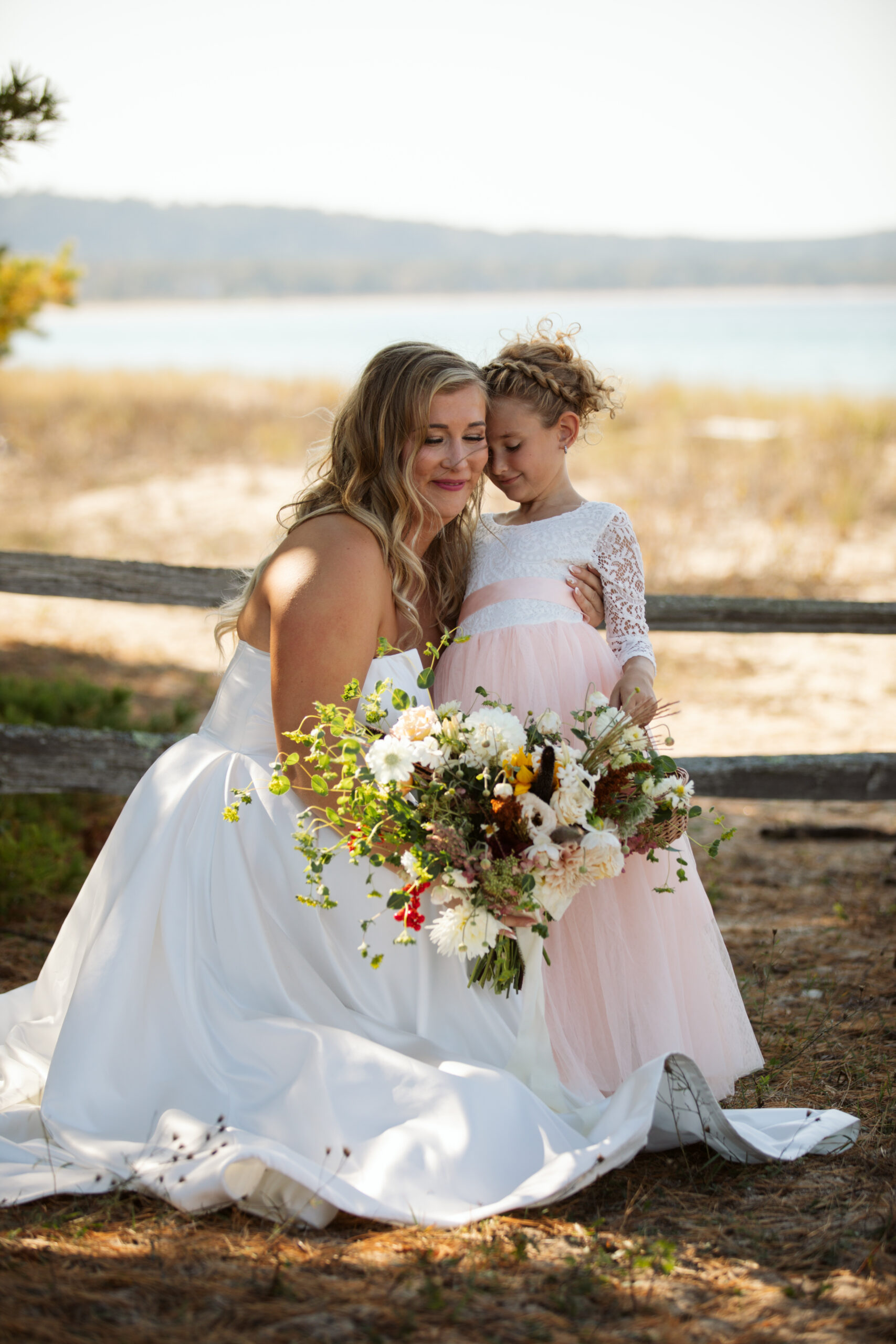 Glen-Arbor-Michigan-Wedding-35 bride and daughter taking a portrait on glen arbor beach on lake michigan