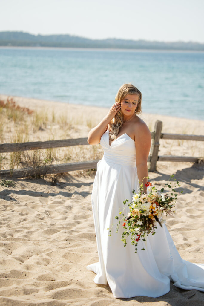 romantic portrait of bride on glen arbor lake michigan beach photo by traverse city wedding photographer
