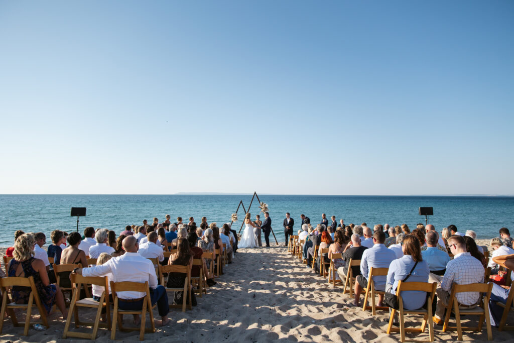 wedding ceremony on beach in glen arbor michigan photo by traverse city wedding photographer