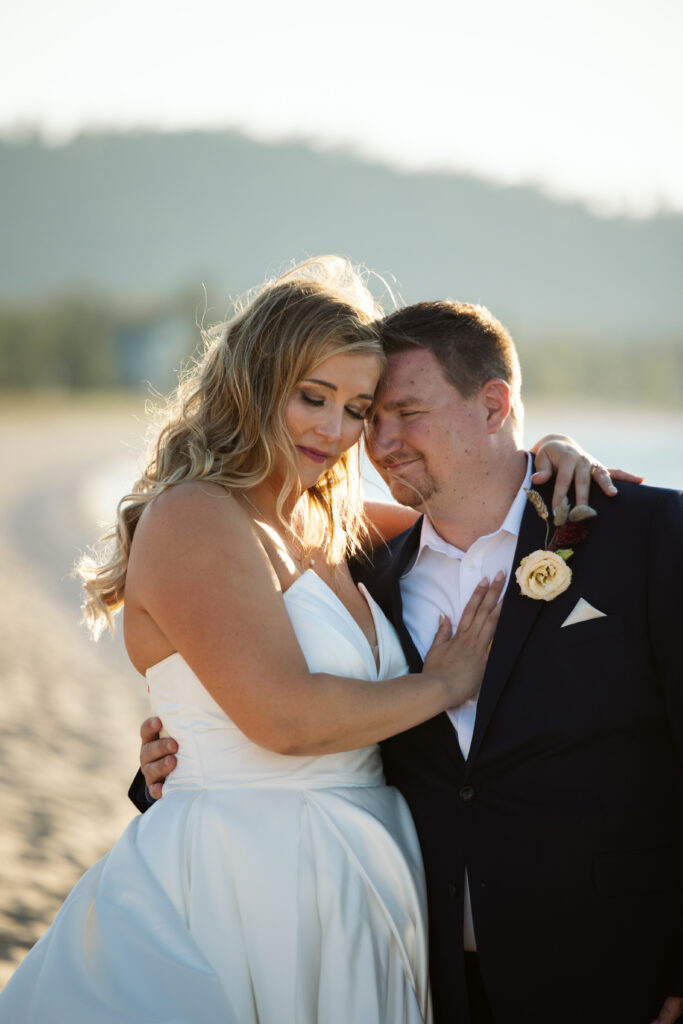 Glen-Arbor-Michigan-Wedding-57 bride and groom holding each other on beach at wedding in glen arbor michigan photo by glen arbor photographer