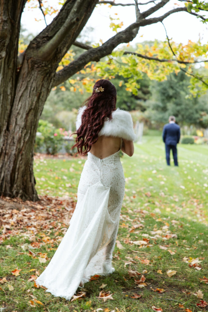 Peninsula-Room-Wedding--11 bride approaching her groom during first look at old mission peninsula peninsula cellars wedding venue