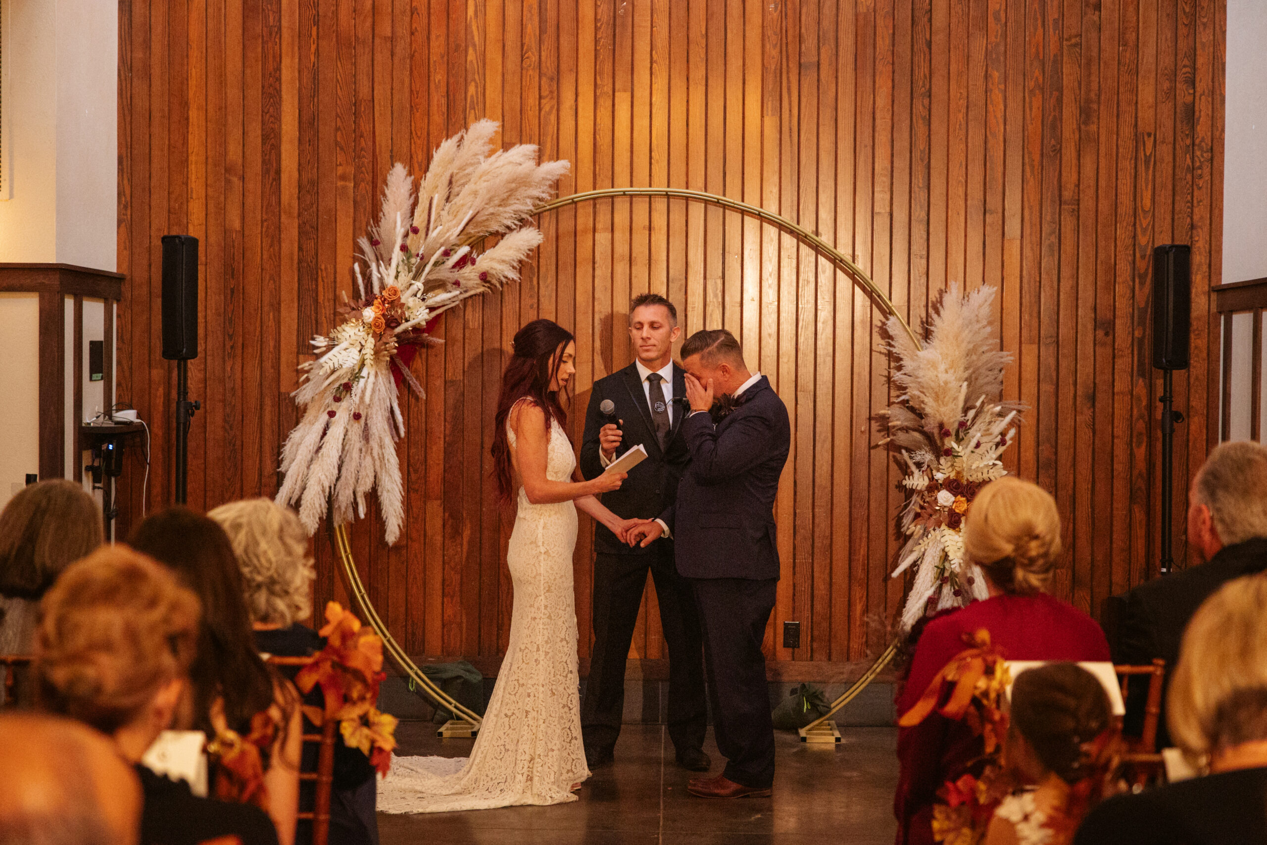 bride and groom facing each other at indoor ceremony at peninsula cellars