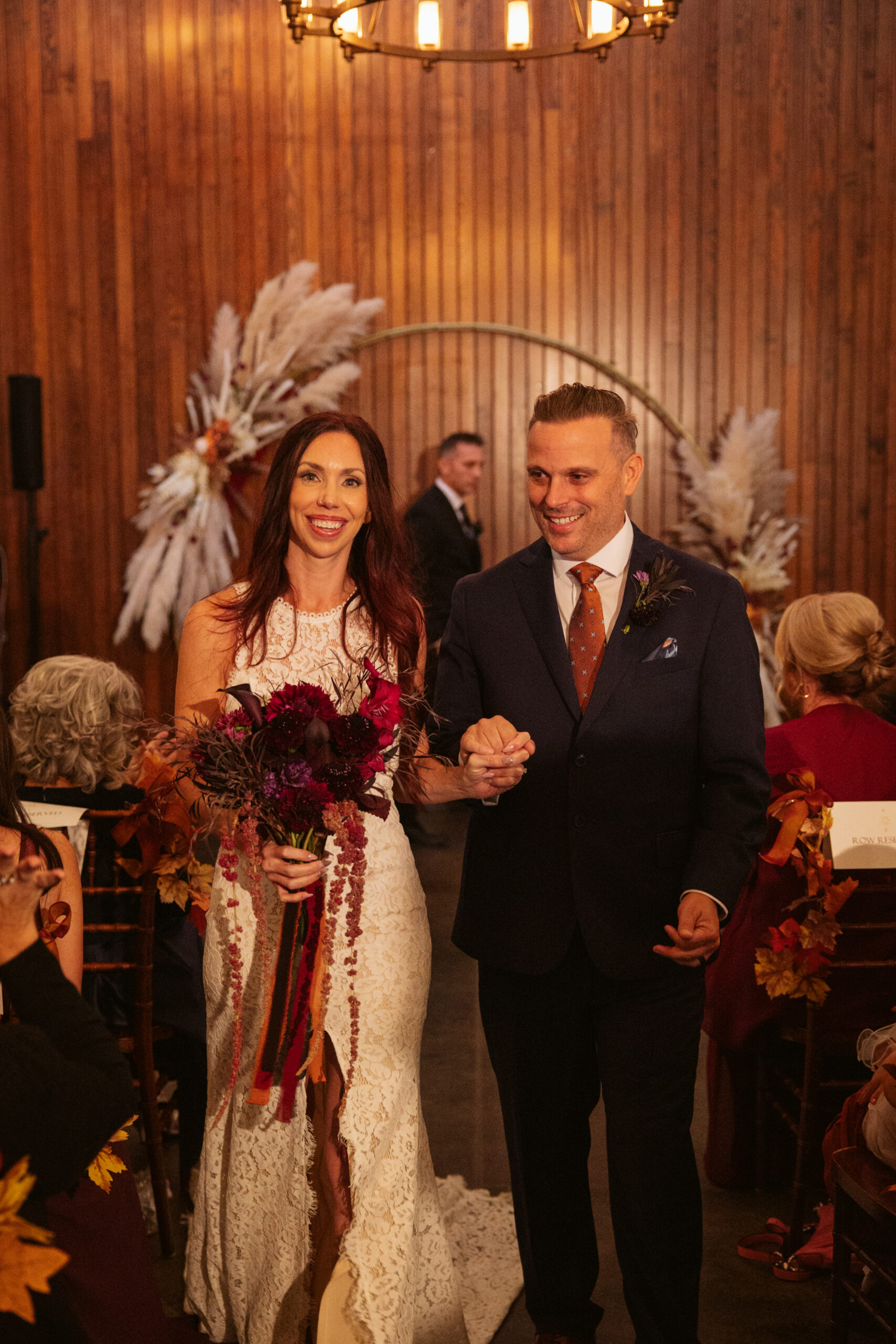 bride and groom walking down aisle at peninsula cellars in traverse city