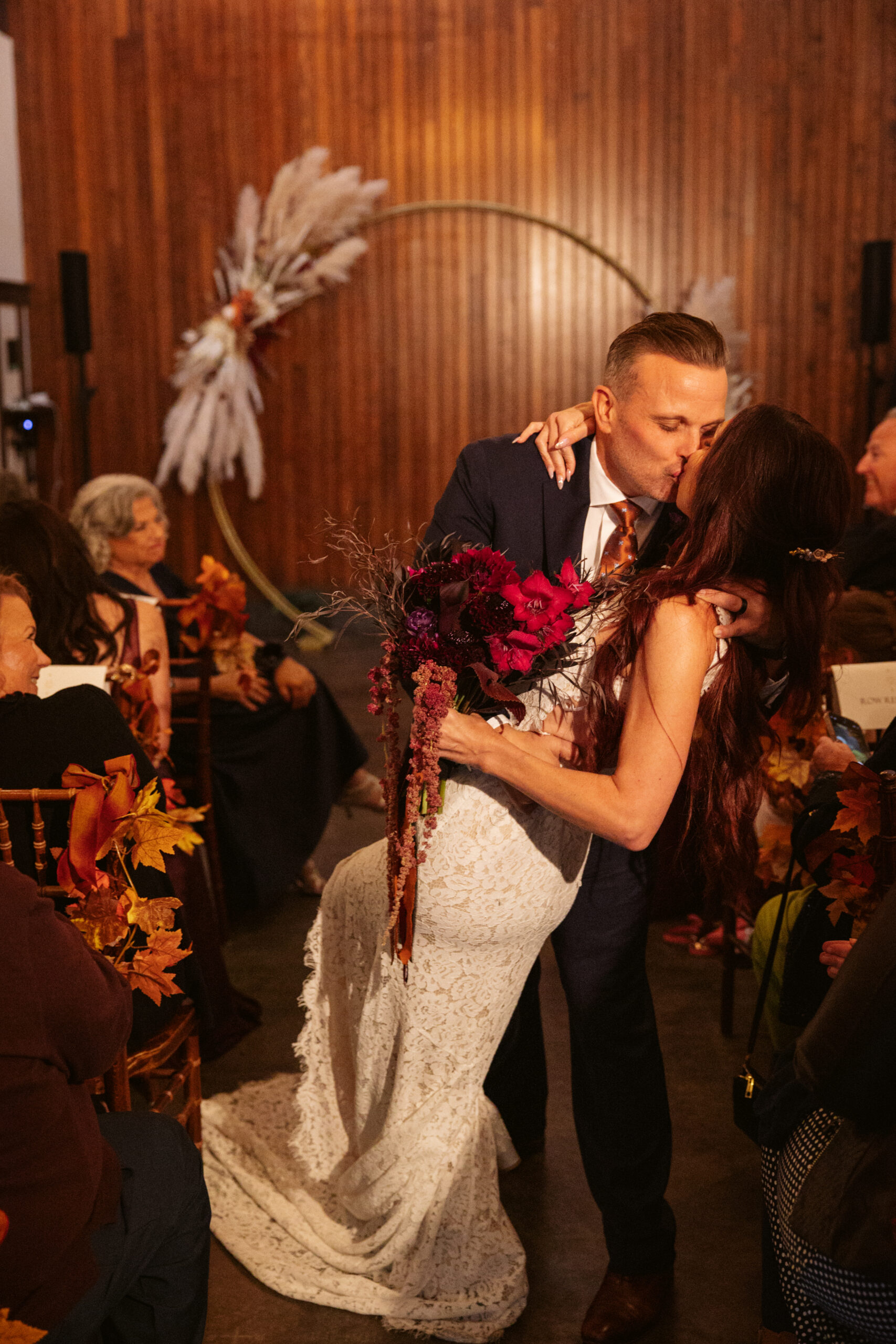 groom dipping bride after peninsula cellars wedding ceremony in traverse city michigan