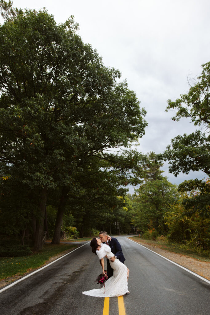 bride and groom kissing in the middle of the road in traverse city michigan