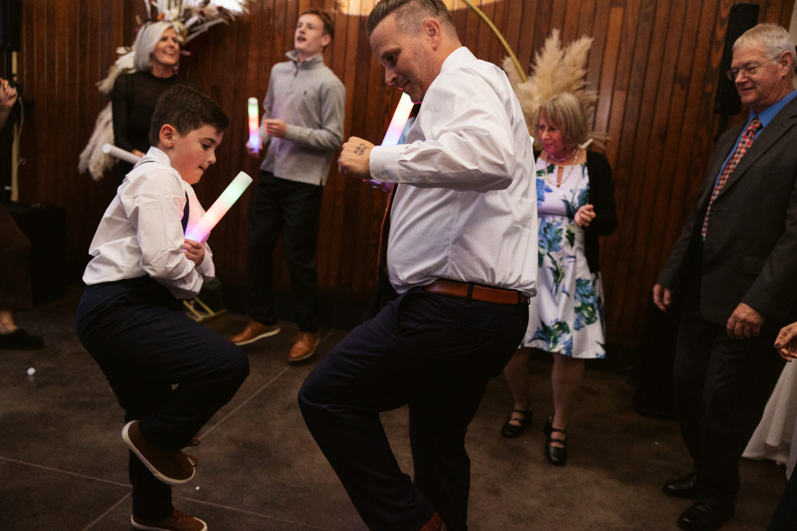groom and boy dancing at reception at peninsula cellars wedding in traverse city michigan