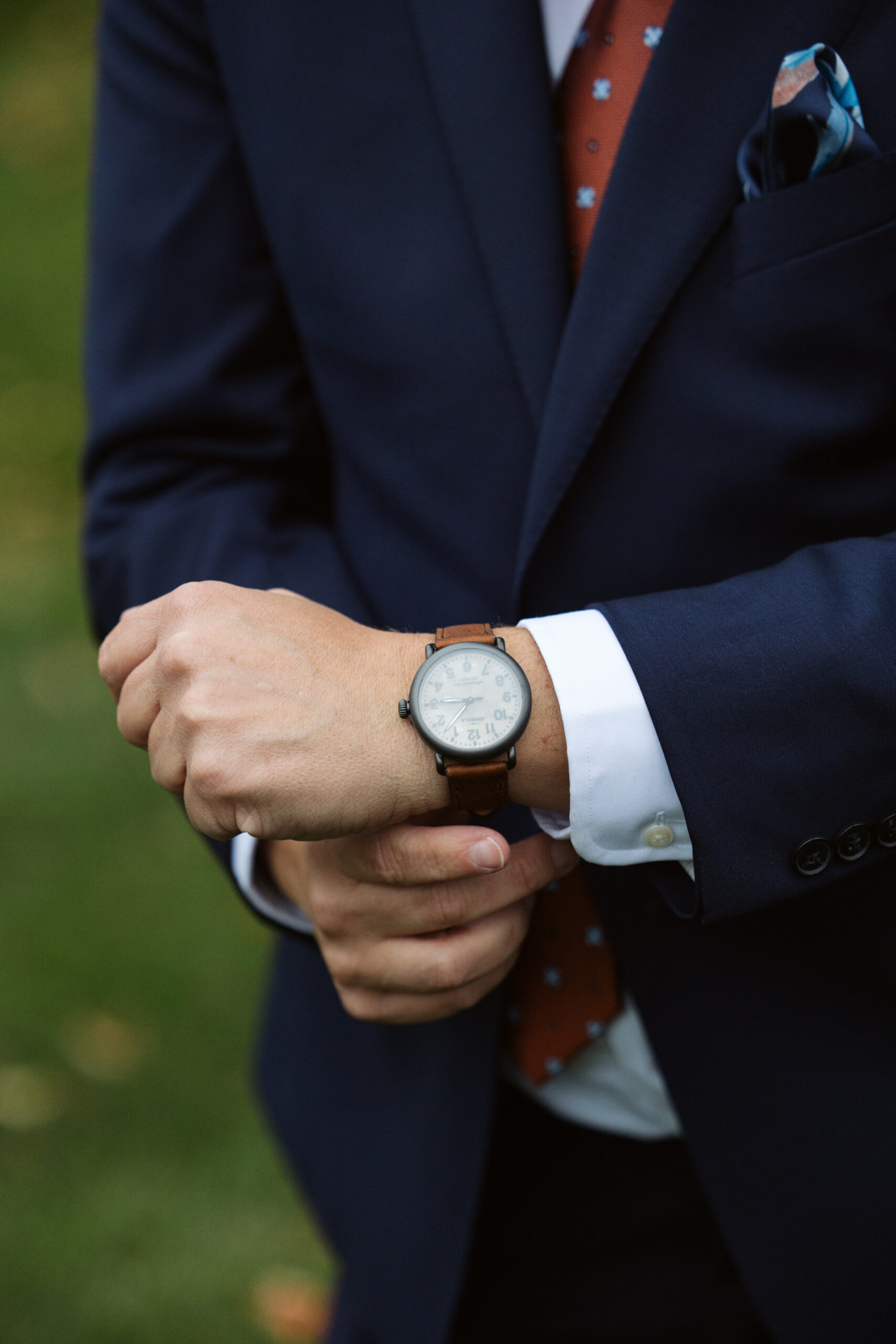 groom showing wedding gift watch at peninsula cellars in traverse city
