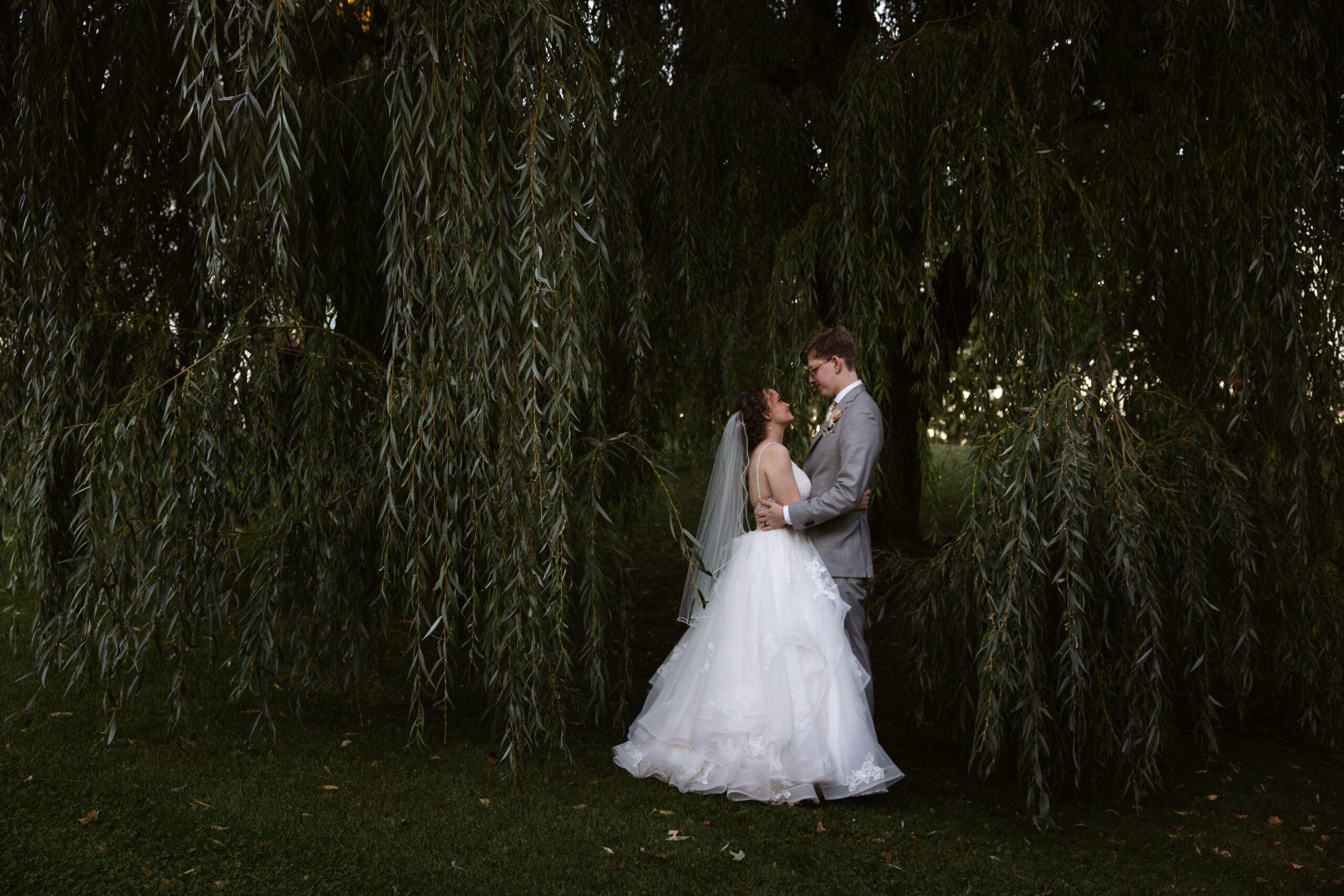 bride and groom dancing in field at starry night barn suttons bay michigan wedding photographer