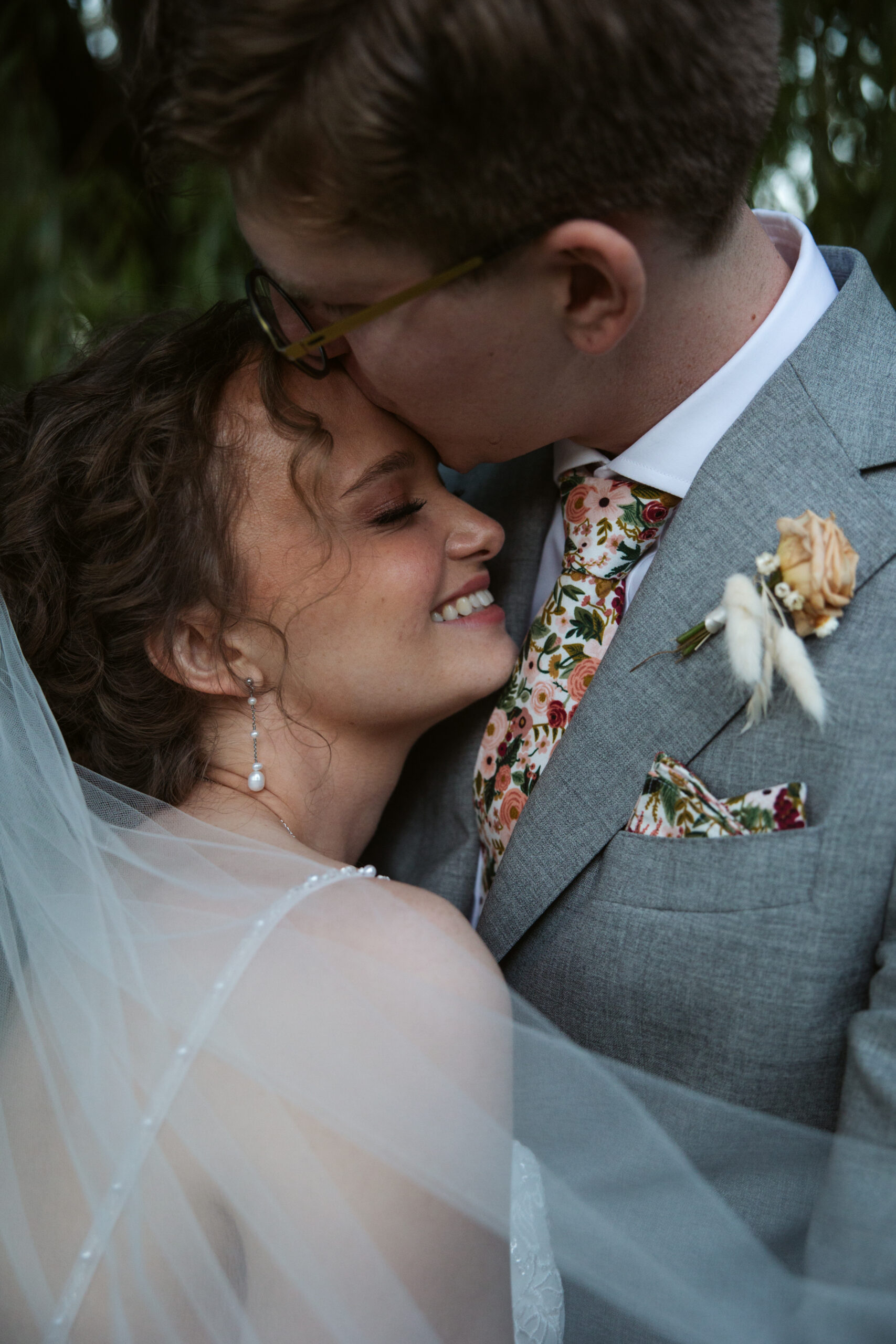 close up of a groom kissing his bride at starry night barn wedding in suttons bay michigan