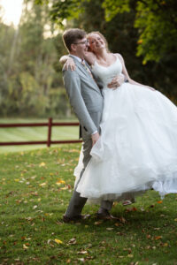 groom spinning his bride around playfully at at starry night barn wedding in suttons bay michigan