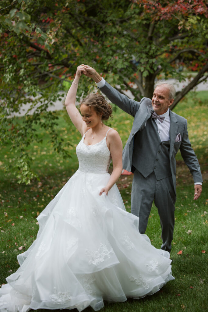 father of the bride dancing with his bride in traverse city michigan
