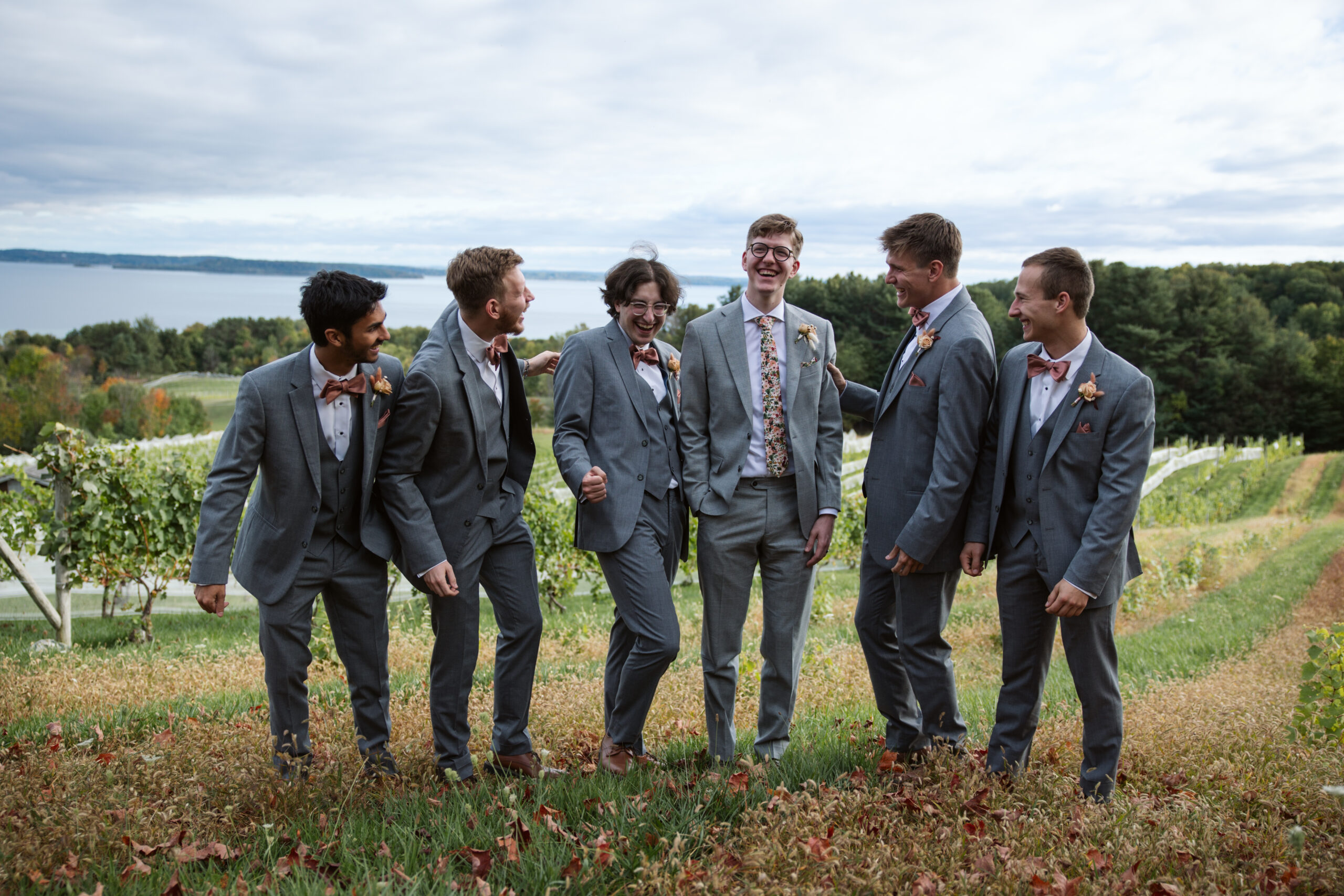 groomsmen standing at the top of vineyard in suttons bay
