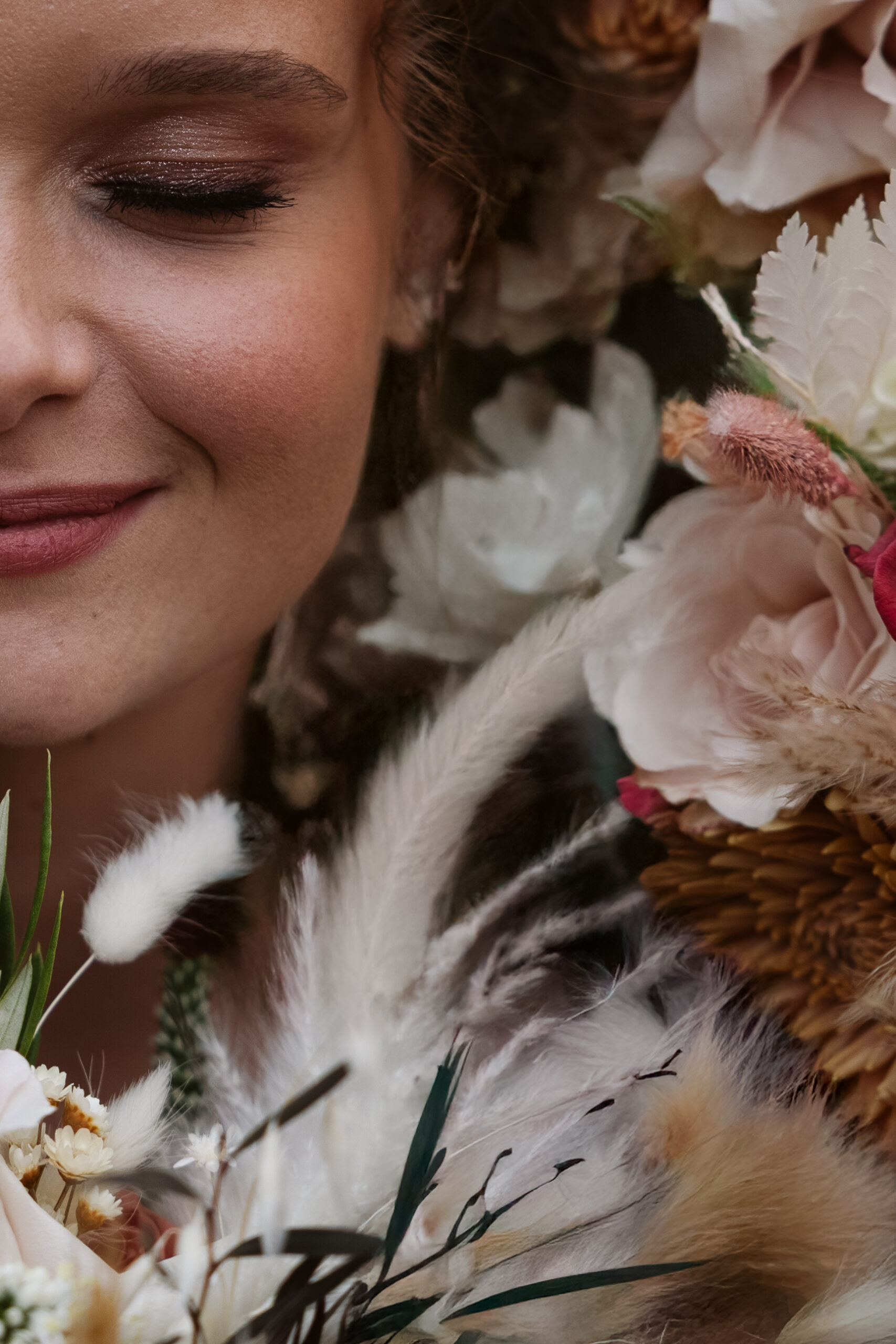 close up of part of a brides face with flowers surrounding her at suttons bay wedding