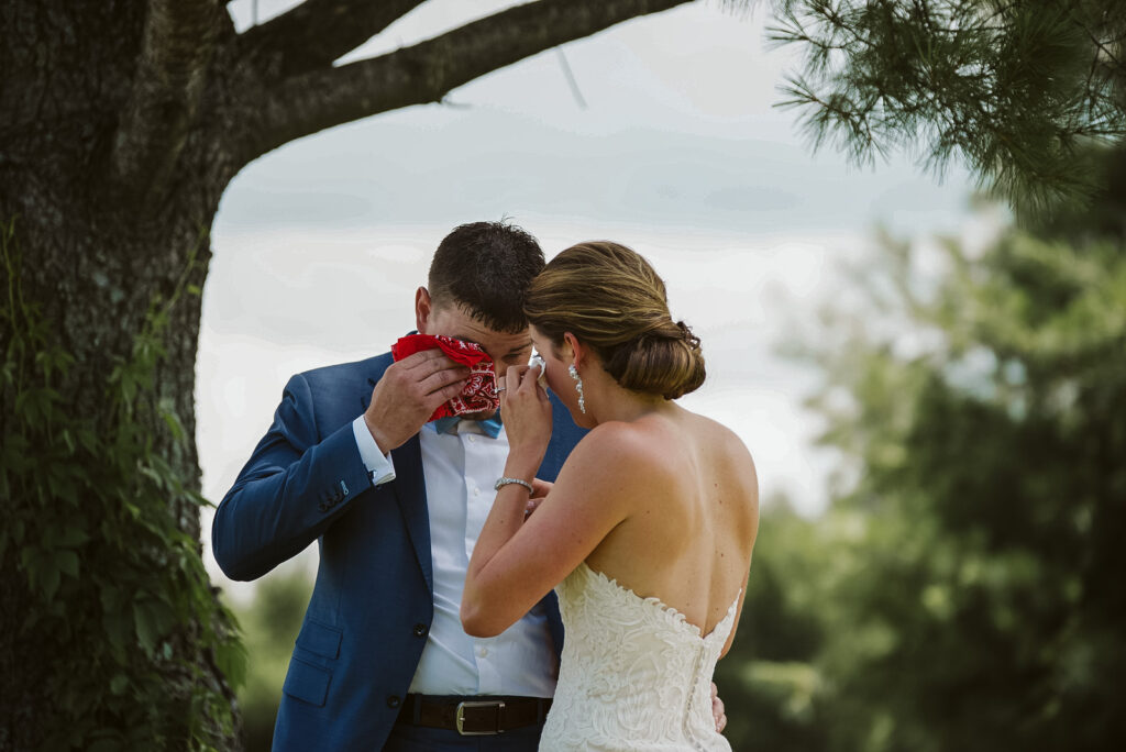 bride and groom crying during first look at traverse city wedding