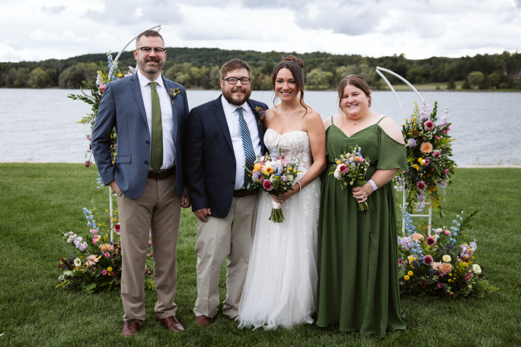bride and groom during family portraits at east jordan boathouse wedding