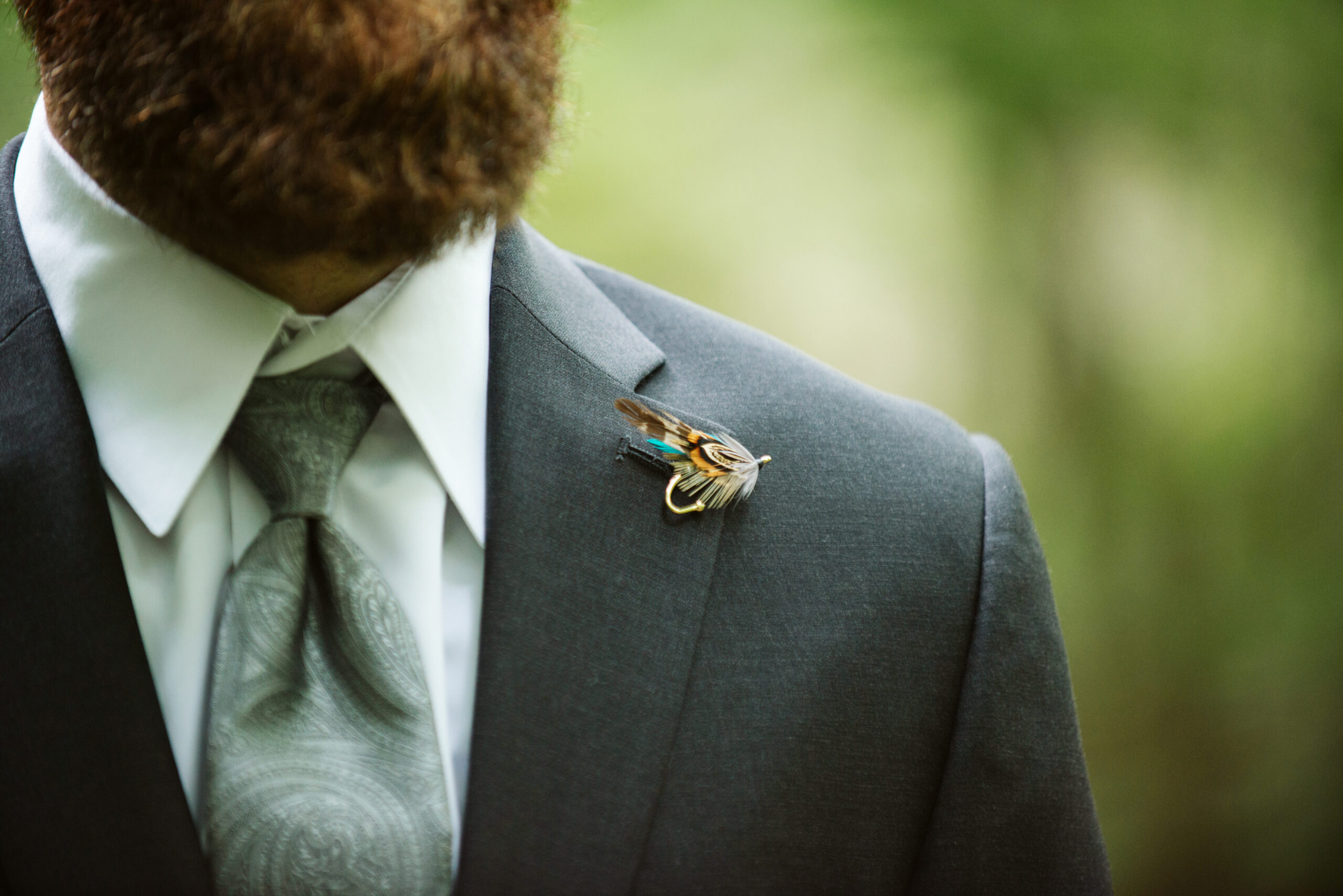 close up of groom lapel during wedding at twin lakes campground in traverse city